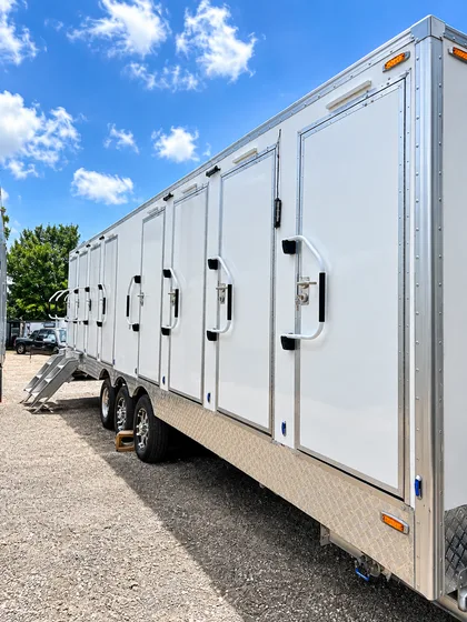 Supplied reference image labelled 30ft luxury shower restroom combination trailer exterior side view.