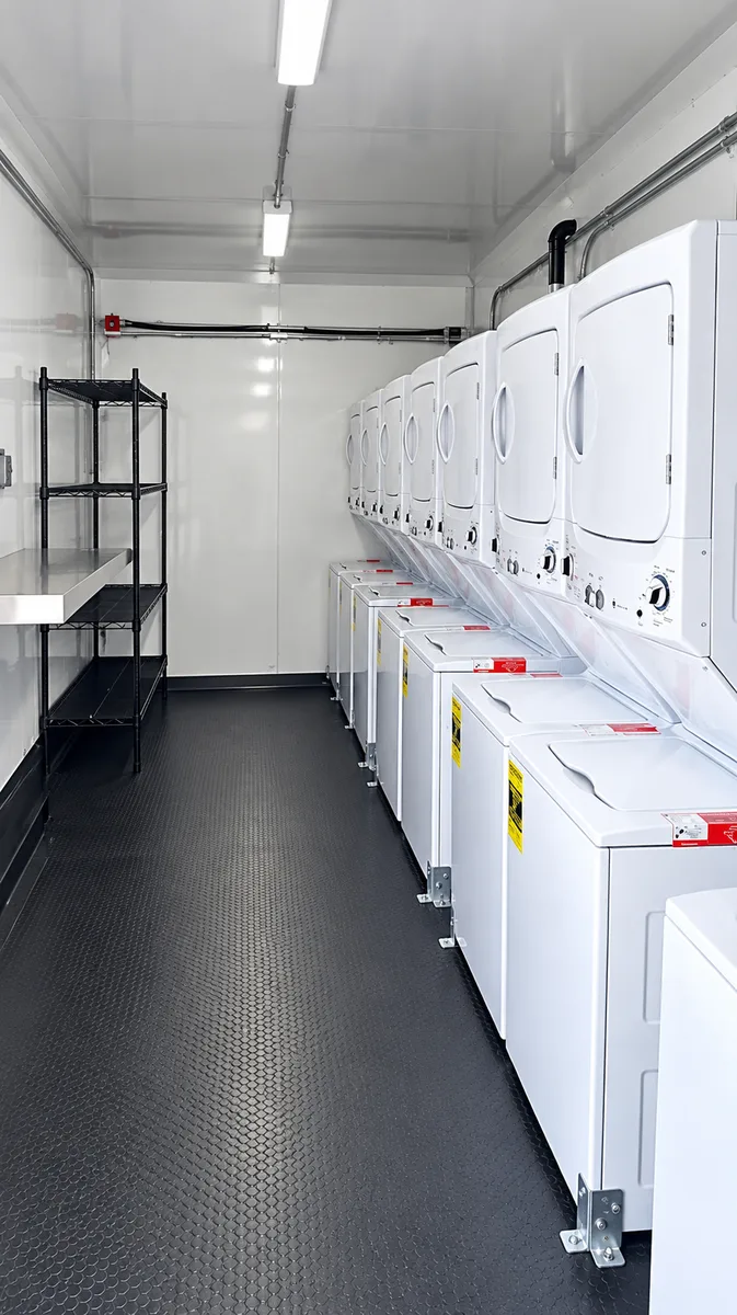 Supplied reference image labelled mobile laundry trailer commercial washers dryers.