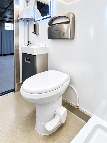 Supplied reference image labelled commercial mobile restroom trailer interior.